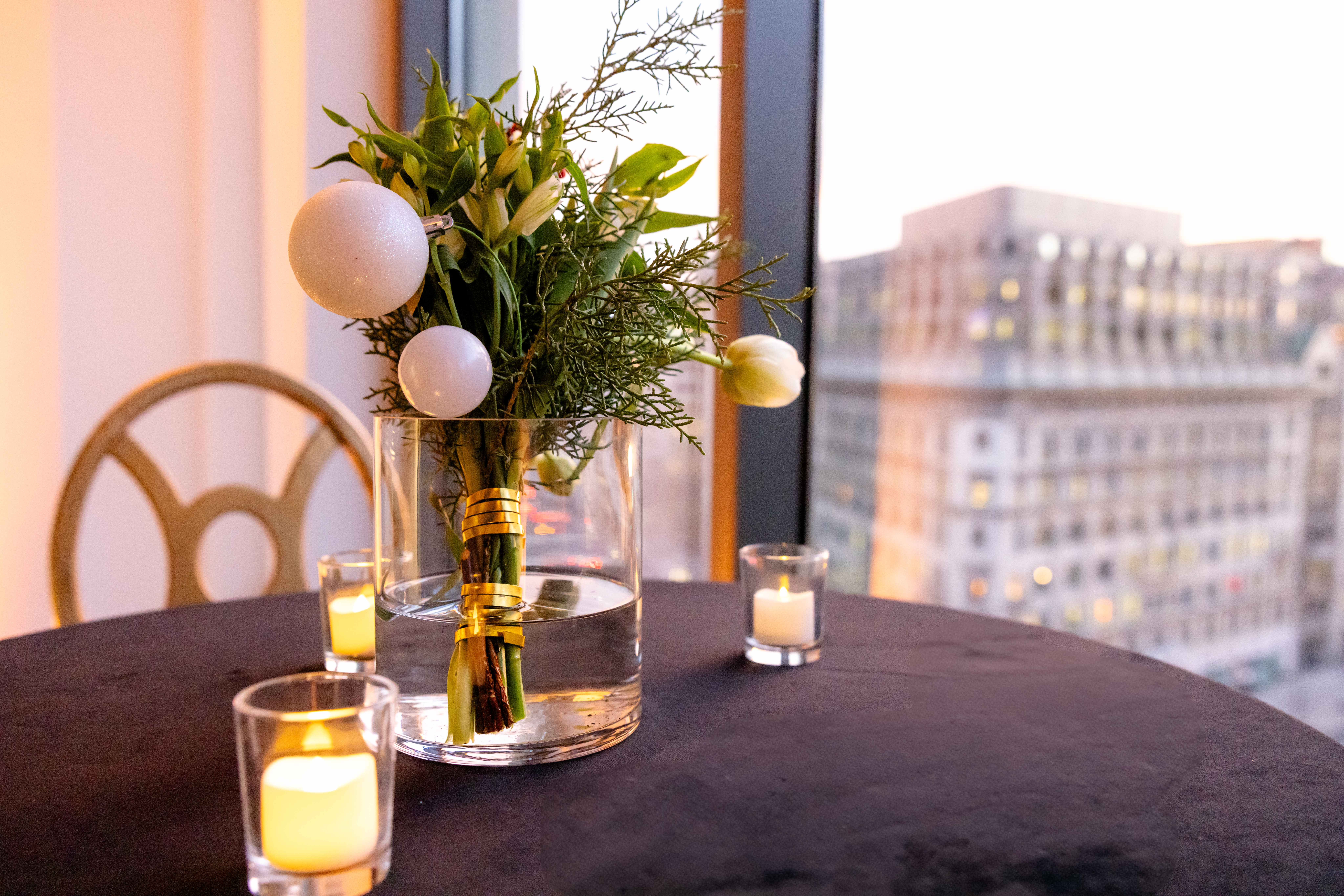Holiday party event space with festive décor, tables, and warm lighting